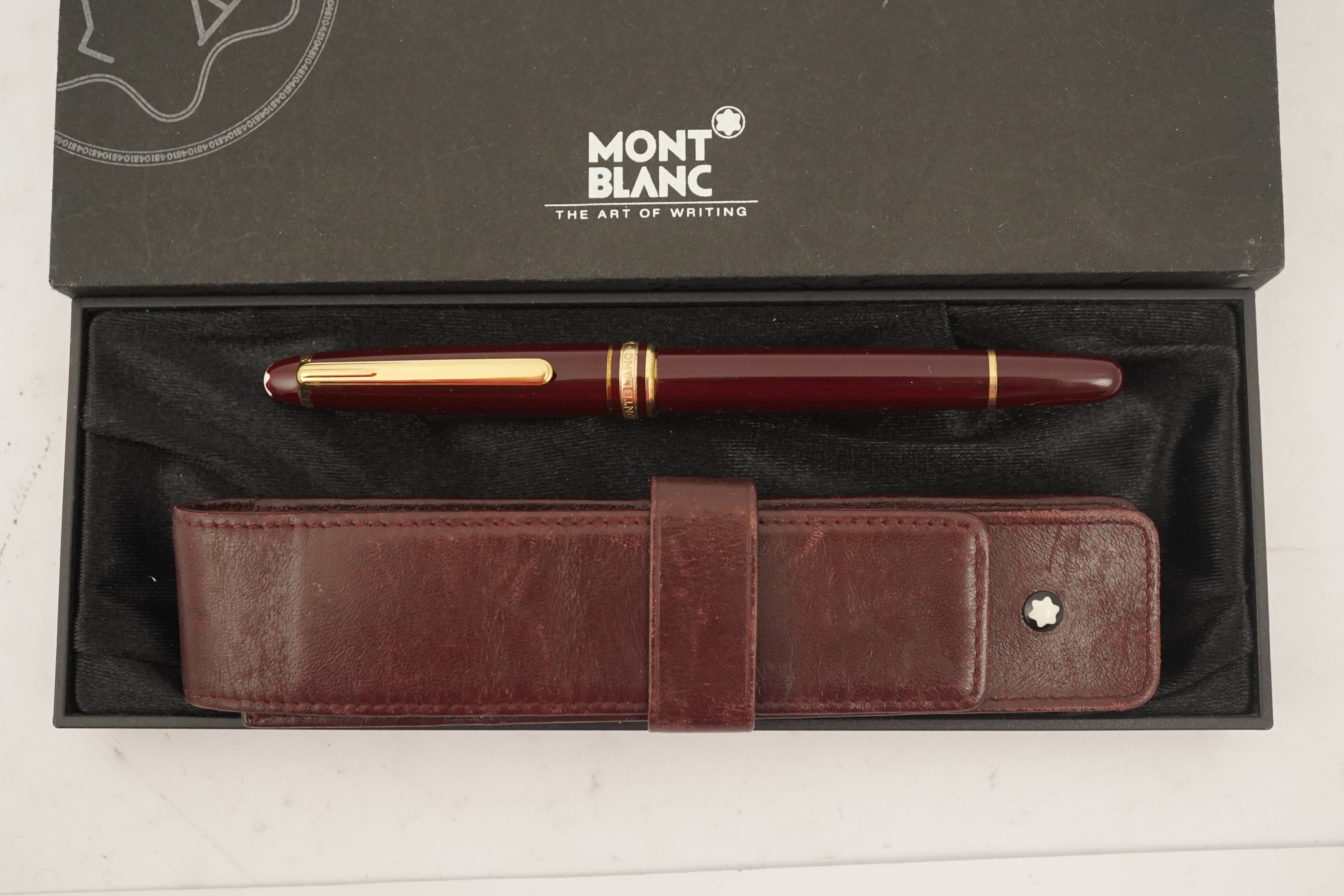 A Mont Blanc Meisterstuck maroon and gilt rollerball pen, boxed with paperwork and leather case